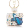 Perfume bottle with crystals and flowers - keychainKeyrings