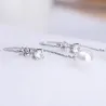 Lange oorbellen met kristal en witte parelOorbellen