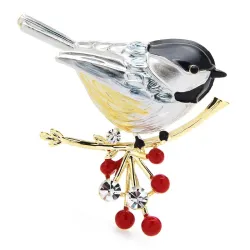 Een vogel zittend op een tak - kristallen brocheBroches