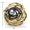 Vogelnest met parel - broche van kristalBroches