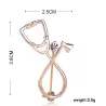 Stethoscope shaped brooch with crystalBrooches