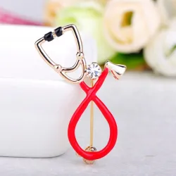 Broche in de vorm van een stethoscoop met kristalBroches