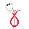 Stethoscope shaped brooch with crystalBrooches