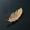 Golden feather brooch - with crystalsBrooches