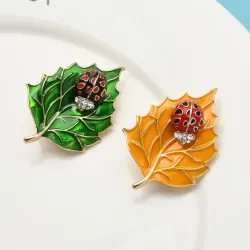 Brooch with beetle and leafBrooches