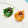 Brooch with beetle and leafBrooches