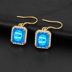 Gouden oorbellen met blauw kristal topaas / strass steentjesOorbellen