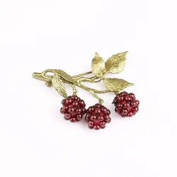 Fruitbroche met granaatappelmotiefBroches
